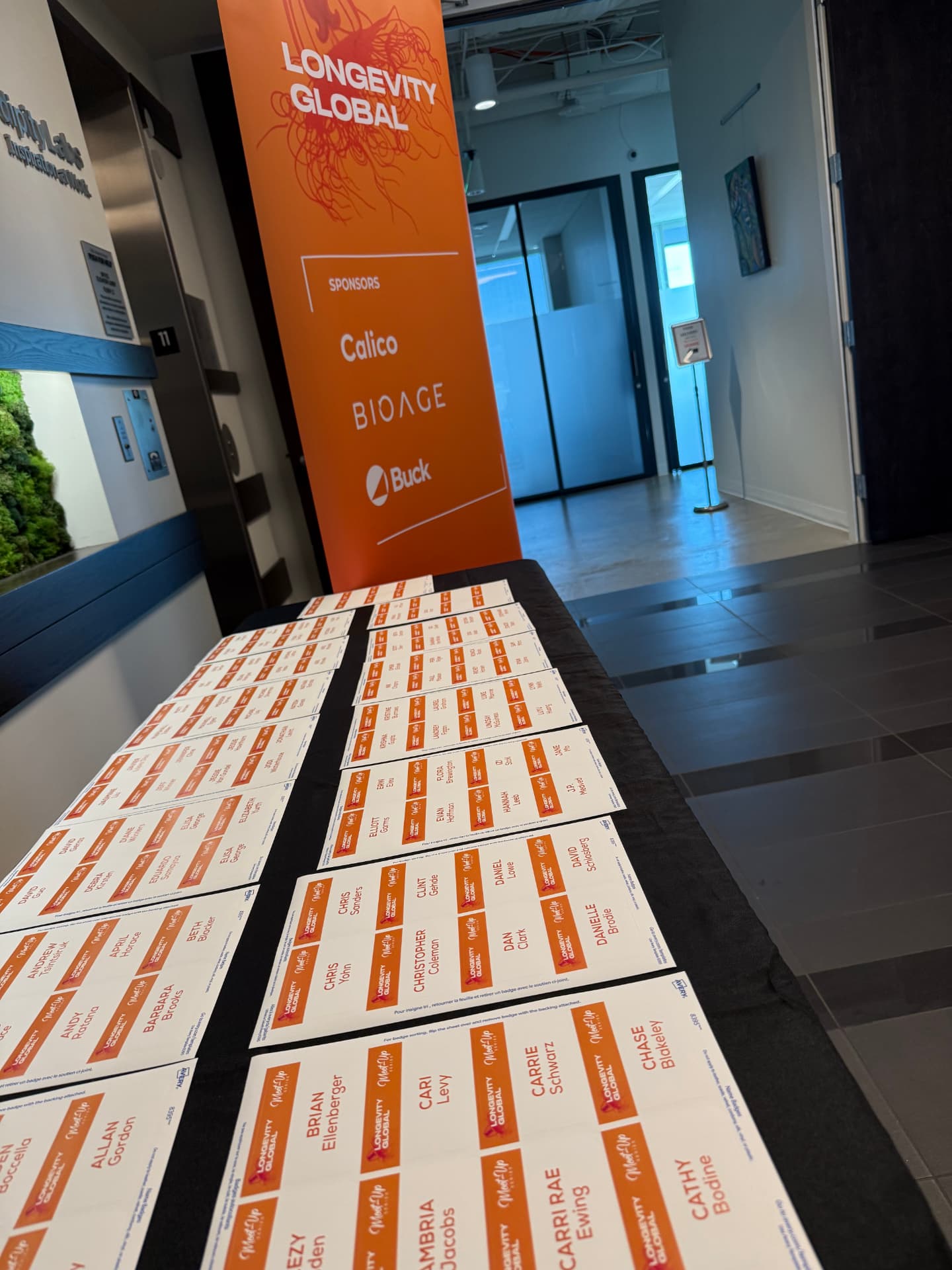 Name badges laid out before a Longevity Global gathering