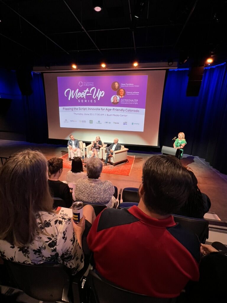 Audience watching a panel at a longevity meet-up